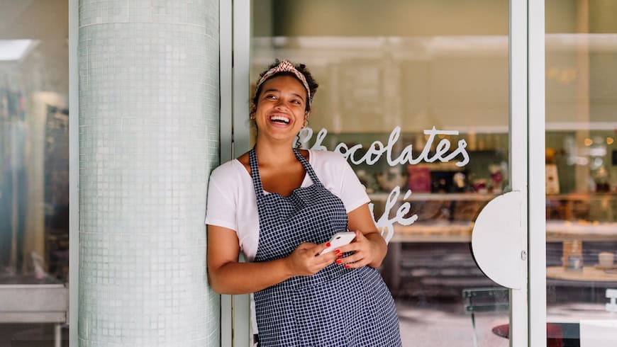 Brazilian business owner in front of shop