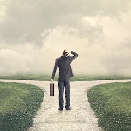 Businessman at crossroads