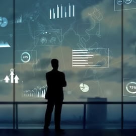 Investor looking out at city skyline with digital symbols around him.
