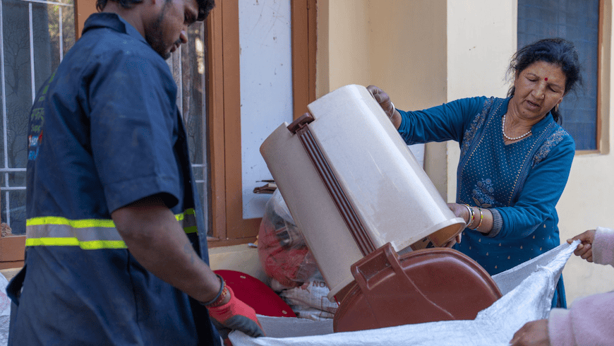 Woman disposing of waste in India