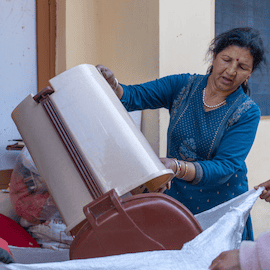 Woman disposing of waste in India