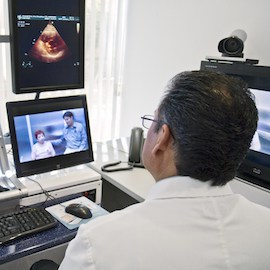A cardiologist in Mexico has a pre-op consultation via video with a patient and her doctor who are 400 miles away in California.