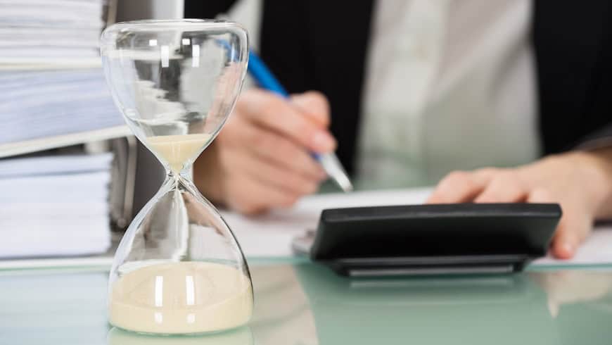 Social innovator with hourglass and paperwork