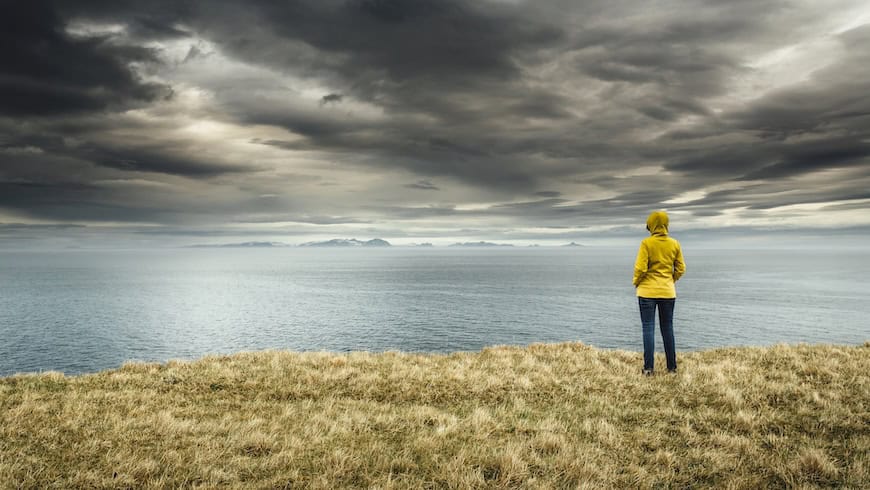 Woman looking out at stormy skies