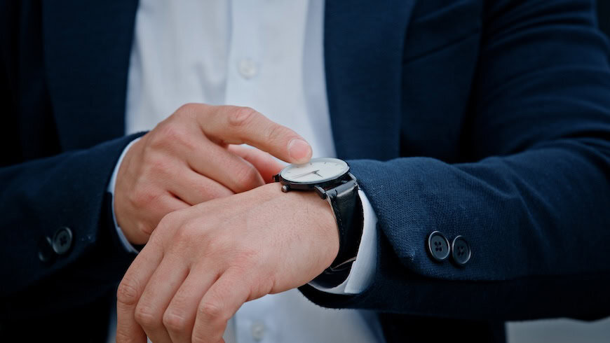 Impatient man in business suit checking watch