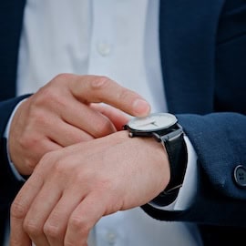 Impatient man in business suit checking watch