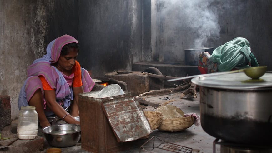 Woman using traditional cookstove