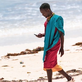 man beach africa kenya smartphone digital phone mobile