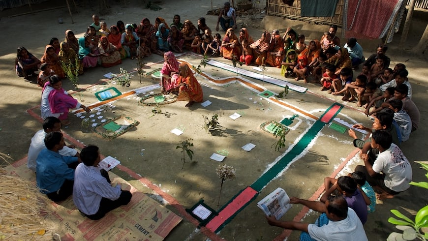 A group of men and women attend a Participatory Rural Appraisal (PRA) in Kaposhatia in Pakchanda union in Hossanipur upazila, Bangladesh.