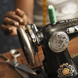 https://www.istockphoto.com/photo/womans-hand-with-old-style-manual-sewing-machine-gm119555651-14640679