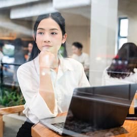 Photo credit: :Tran Van Quyet / https://www.istockphoto.com/photo/thoughtful-woman-works-on-laptop-in-cafe-reflecting-city-life-through-the-glass-gm2212881927-629793149