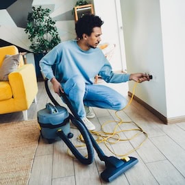 https://www.istockphoto.com/photo/young-man-cleaning-his-living-room-with-a-vacuum-cleaner-preparing-the-apartment-for-gm2217292634-633889668