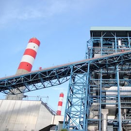 https://www.istockphoto.com/photo/power-plant-showcases-intricate-blue-steel-infrastructure-with-striped-chimney-stacks-gm2249225342-663017066